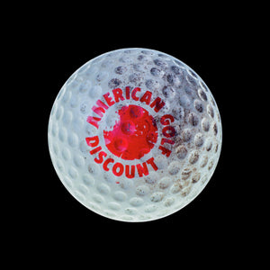 White golf ball that says "American golf discount" in red print
