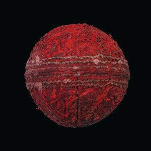 Red cricket ball on black background print 