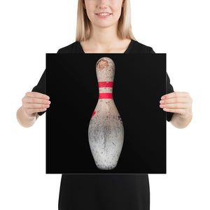 Woman holding red and white bowling print on black background