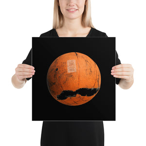 Woman holding orange and black basketball poster on black background
